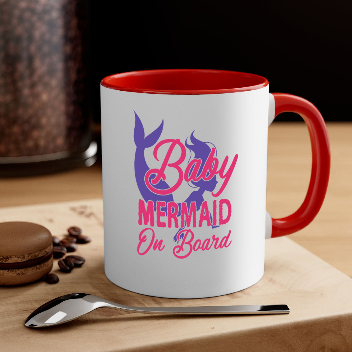 A colorful Baby Mermaid On Board mug with a glossy finish, featuring a mermaid design and a C-shaped handle, available in multiple colors.