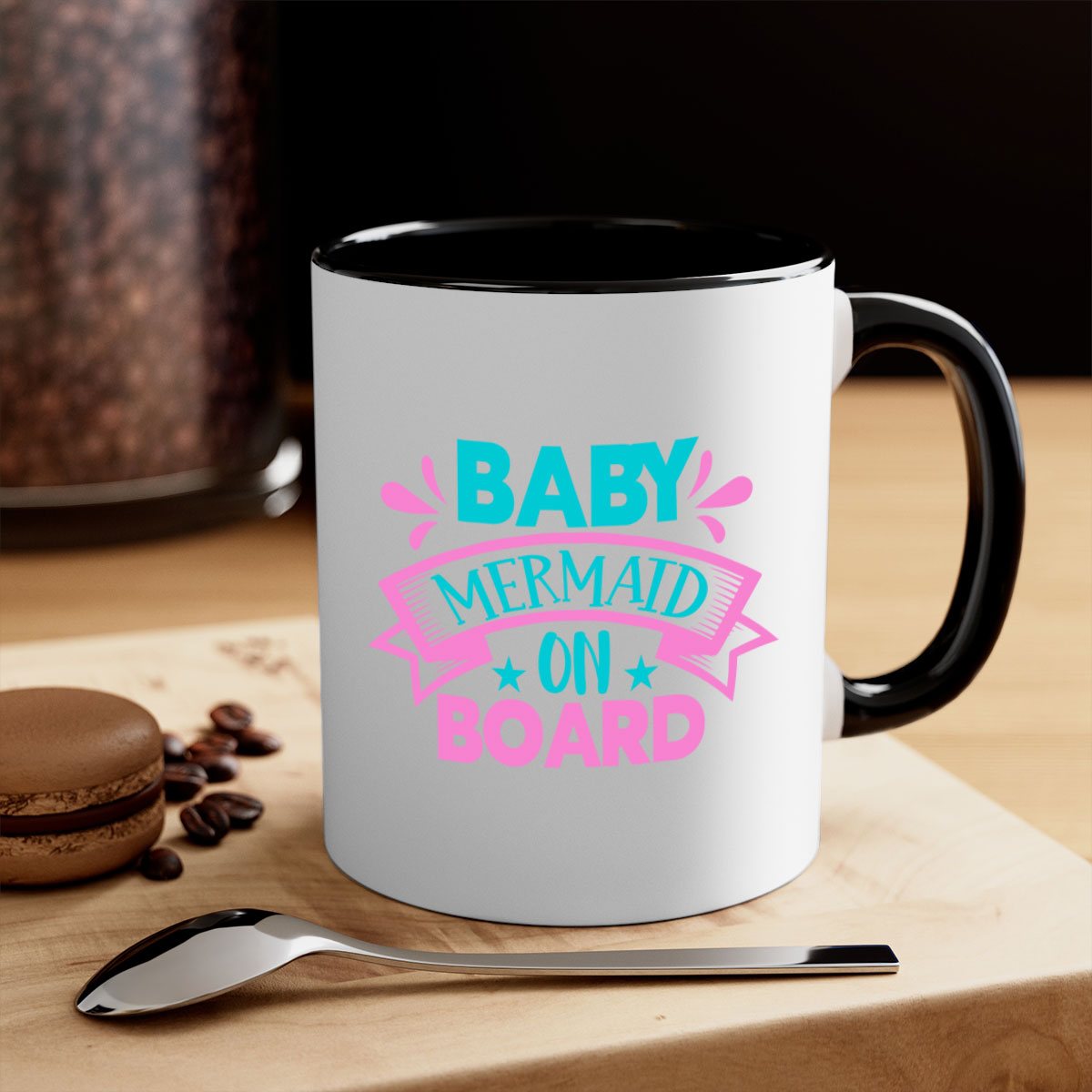 A colorful Baby Mermaid On Board mug with a glossy finish, featuring a mermaid design and a C-shaped handle, available in multiple colors.
