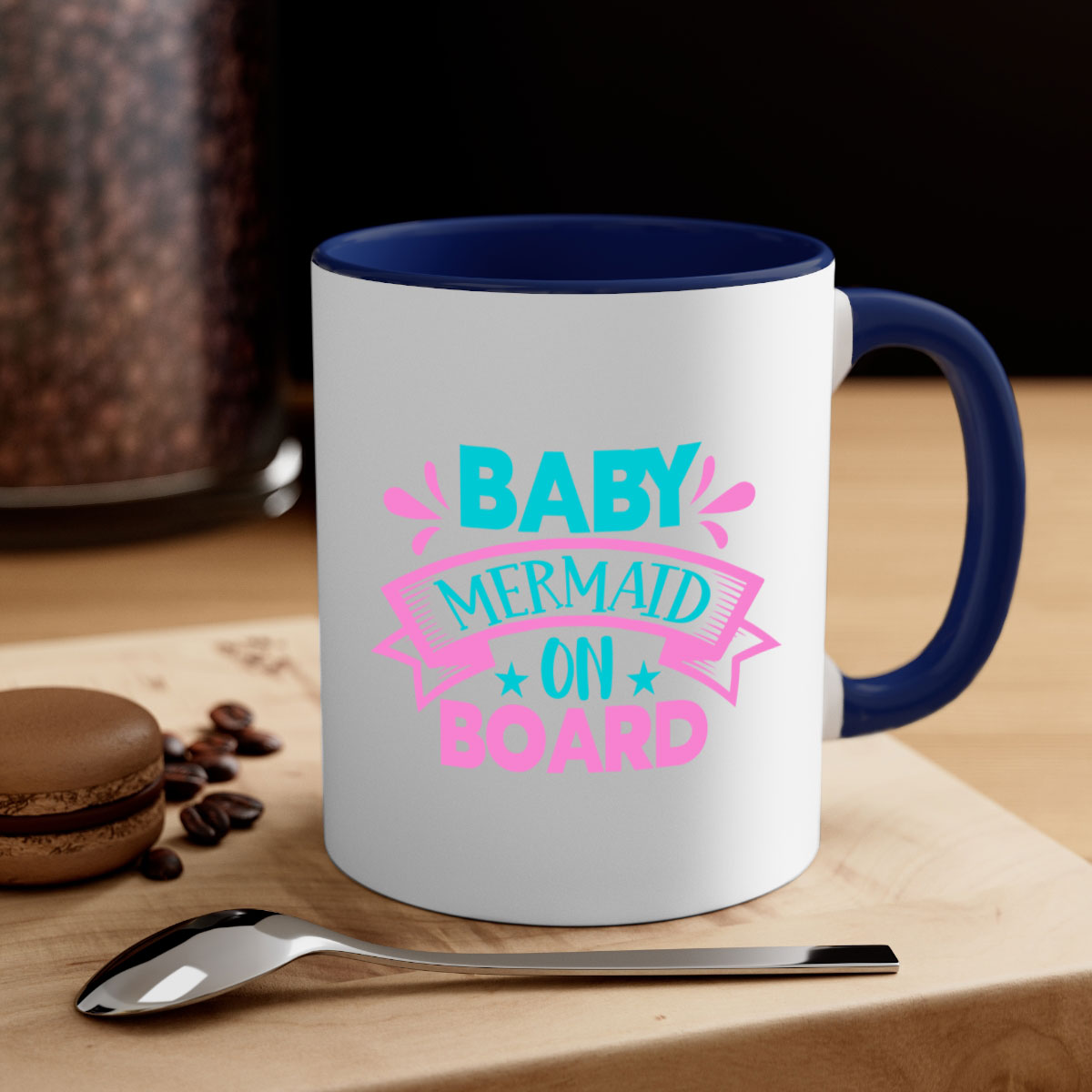 A colorful Baby Mermaid On Board mug with a glossy finish, featuring a mermaid design and a C-shaped handle, available in multiple colors.