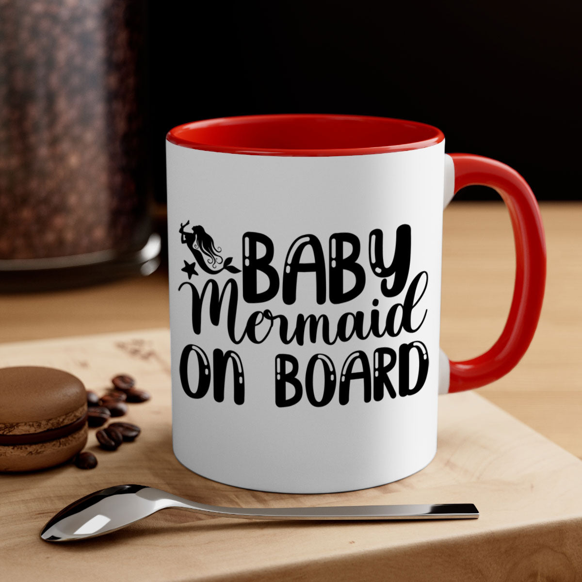 A colorful Baby Mermaid on Board mug with a glossy finish, featuring a mermaid design and a C-shaped handle, available in multiple colors.