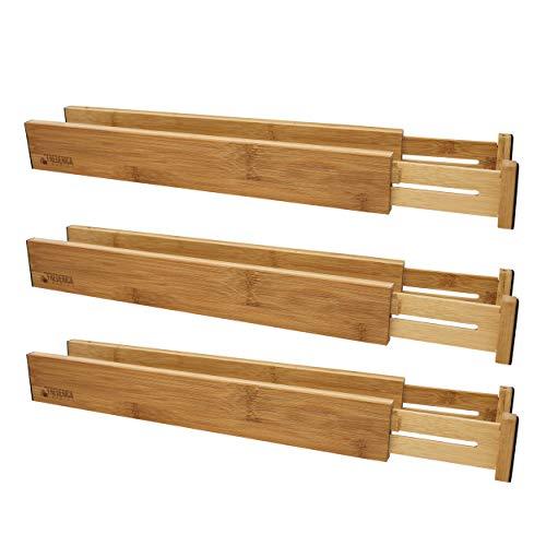 Bamboo adjustable spring-loaded drawer dividers stacked in a kitchen drawer, showcasing their elegant design and functionality.