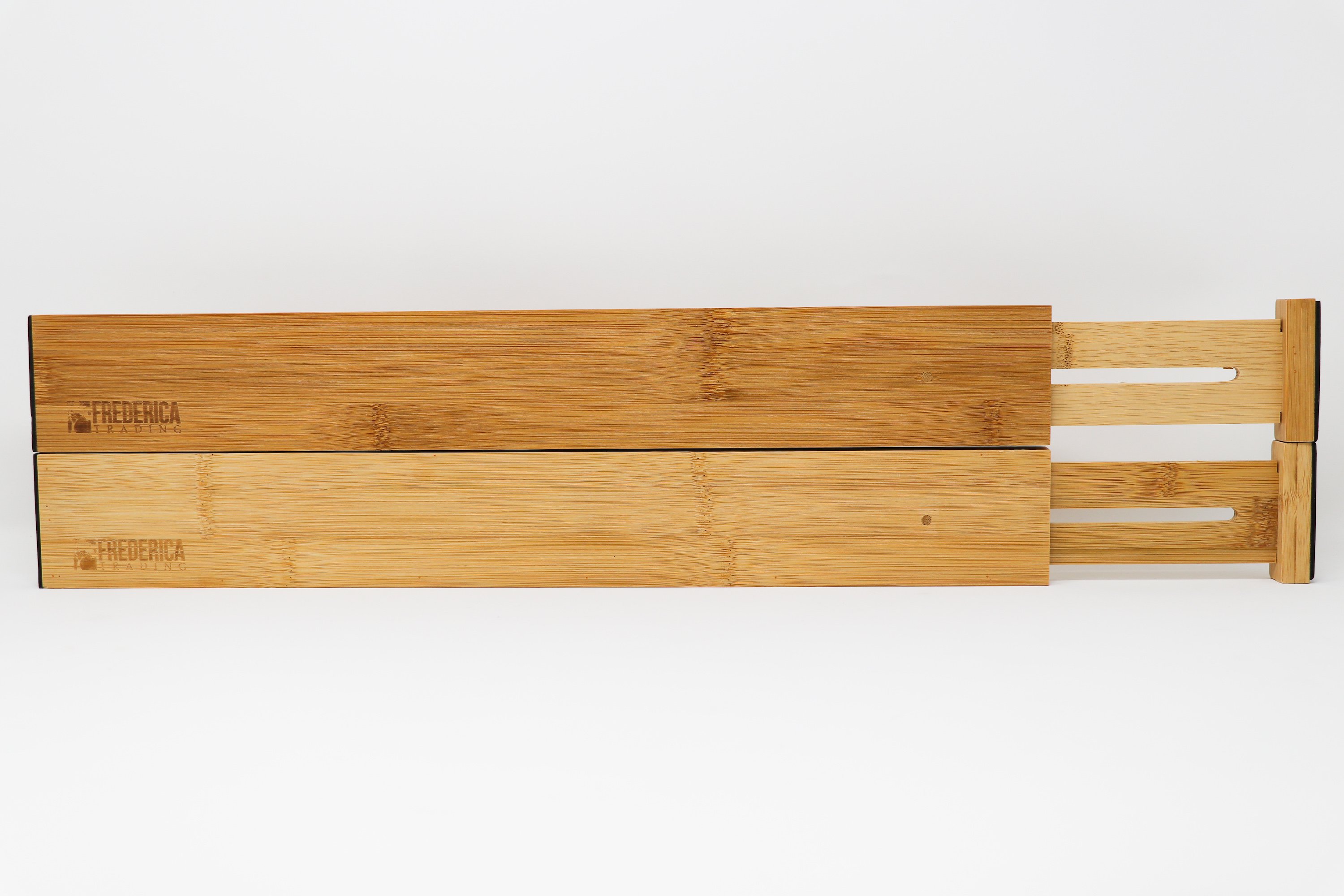 Bamboo adjustable spring-loaded drawer dividers stacked in a kitchen drawer, showcasing their elegant design and functionality.