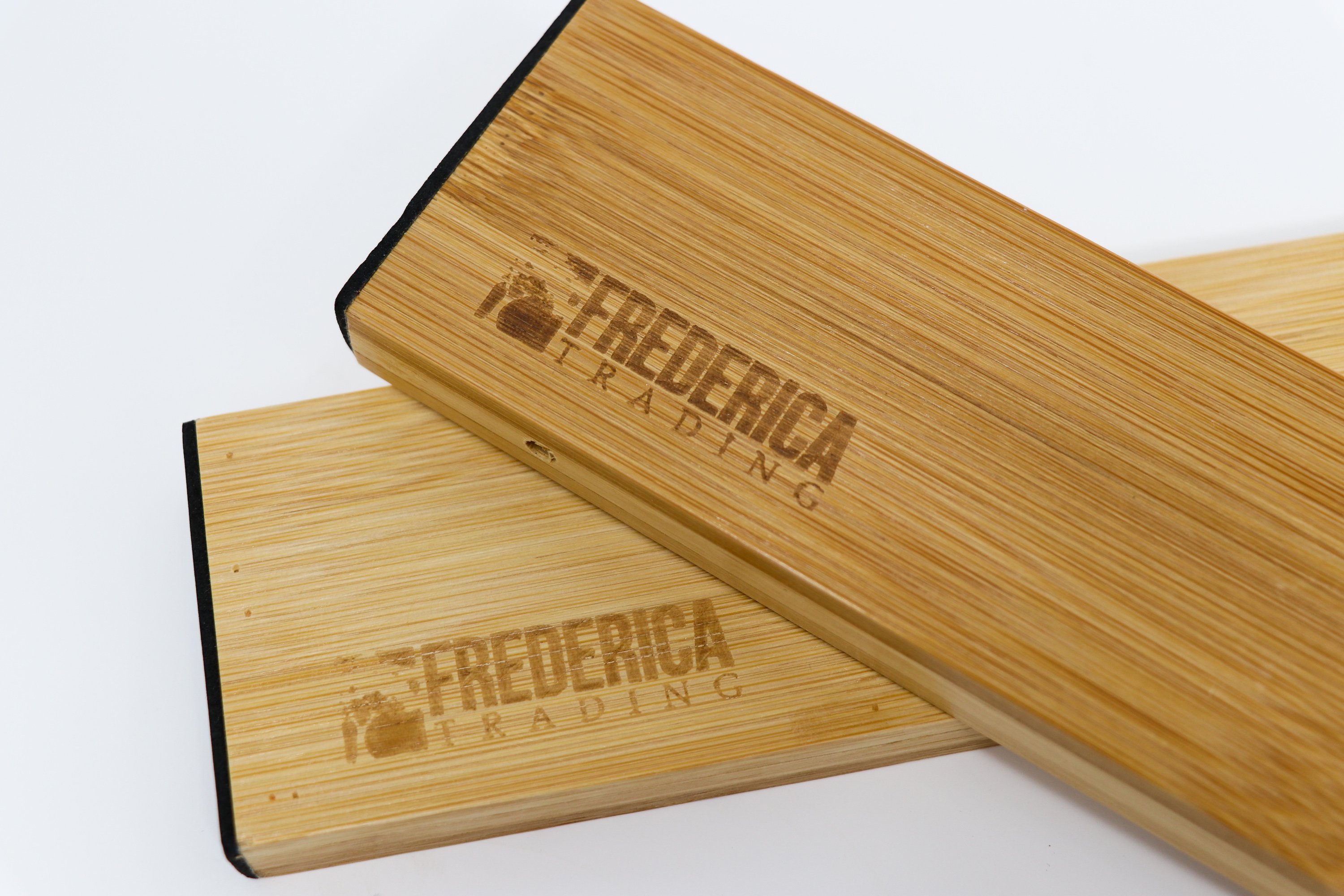 Bamboo adjustable spring-loaded drawer dividers stacked in a kitchen drawer, showcasing their elegant design and functionality.