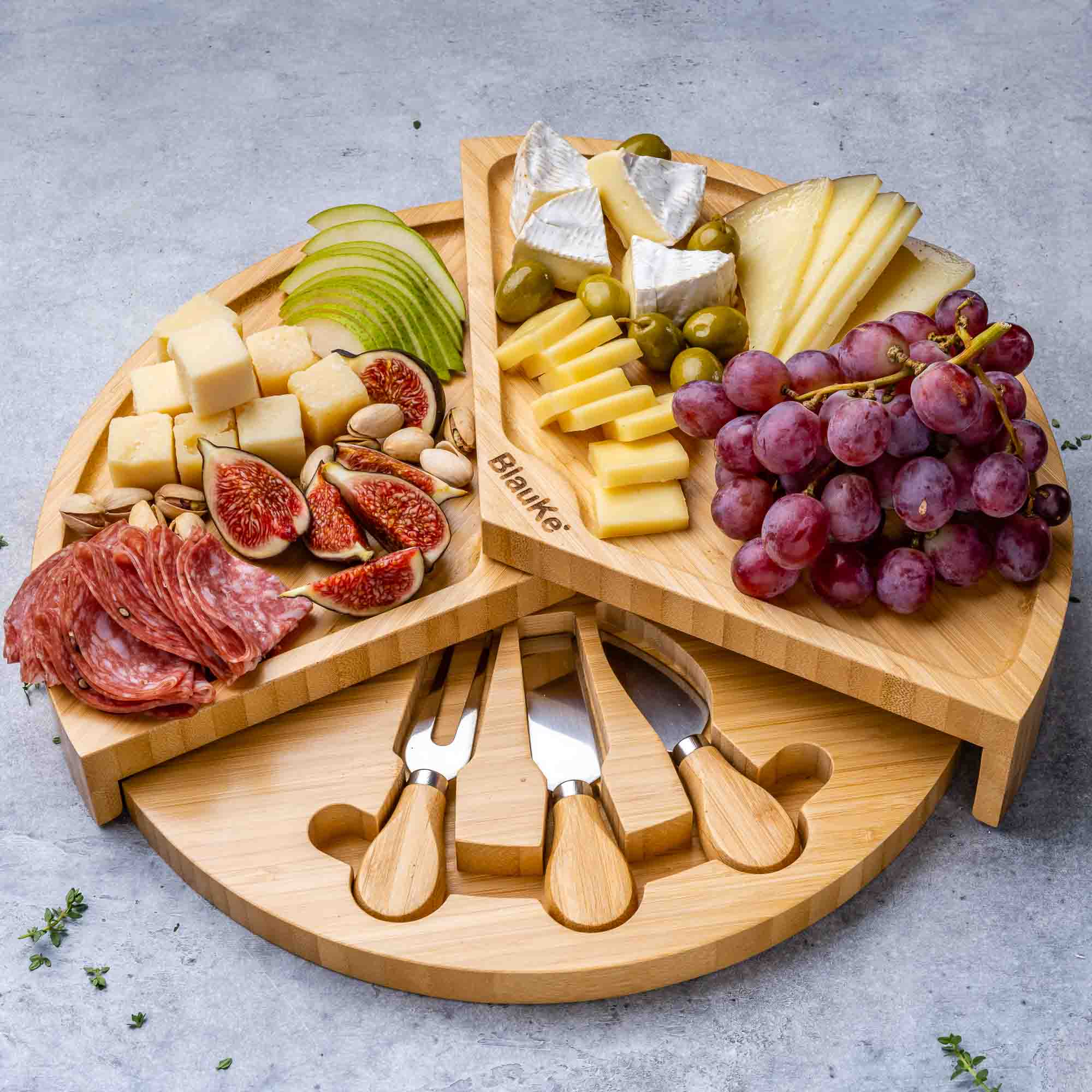 A stylish 14-inch bamboo cheese board with a knife set, featuring a smooth surface and hidden drawer for cheese tools, perfect for charcuterie presentations.