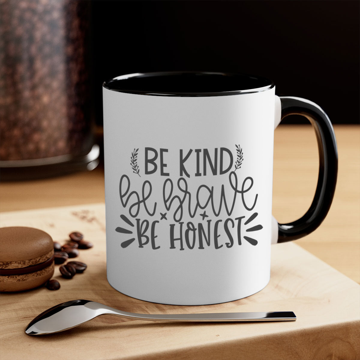 A stylish two-tone ceramic mug with a motivational quote 'be kind be brave be honest', featuring a colored handle and glossy finish.