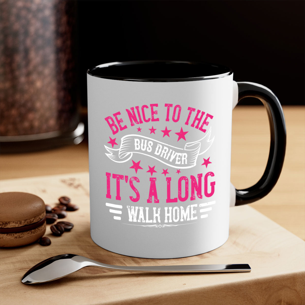 A stylish two-tone ceramic mug with a colored handle and interior, featuring the phrase 'be nice to the bus driver it's a long walk homee'.