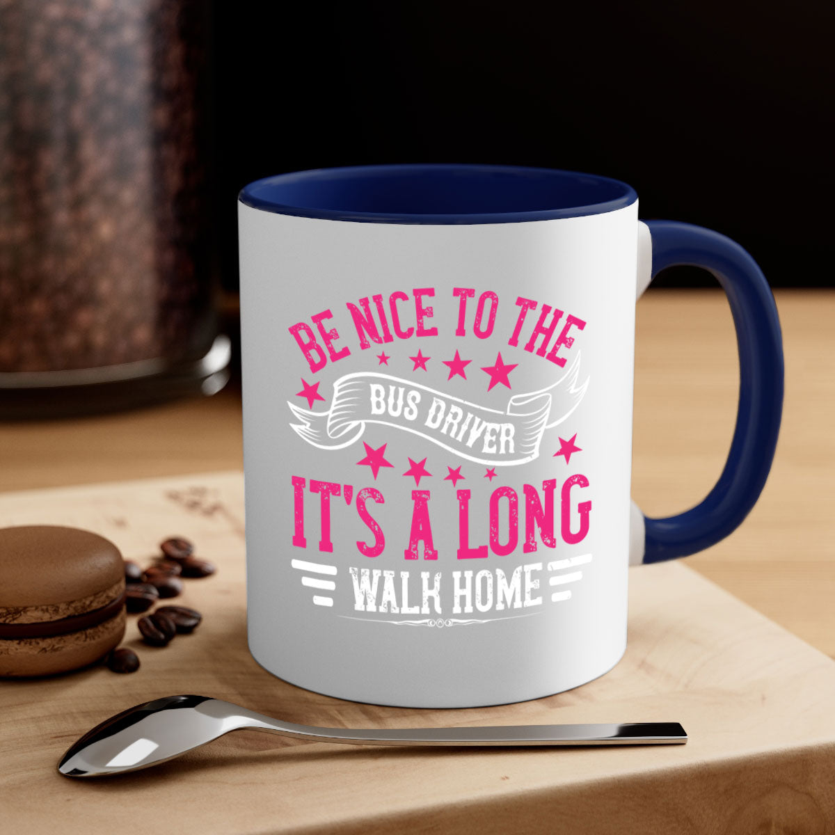 A stylish two-tone ceramic mug with a colored handle and interior, featuring the phrase 'be nice to the bus driver it's a long walk homee'.