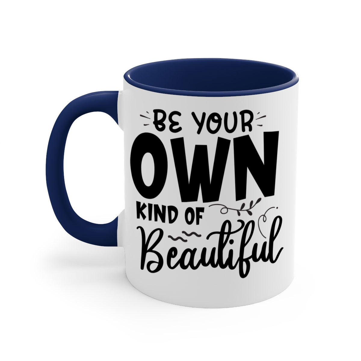 A stylish two-tone ceramic coffee mug with a glossy finish, featuring the phrase 'Be Your Own Kind of Beautiful' and a comfortable C-shaped handle.