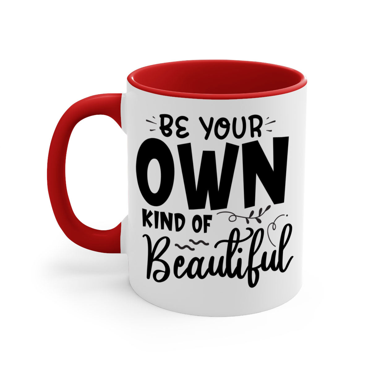 A stylish two-tone ceramic coffee mug with a glossy finish, featuring the phrase 'Be Your Own Kind of Beautiful' and a comfortable C-shaped handle.