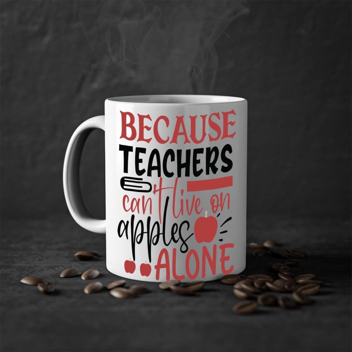 A two-tone ceramic mug with a colored handle and interior, featuring the phrase 'Because Teachers Can't Live on Apples Alone' in a stylish font.