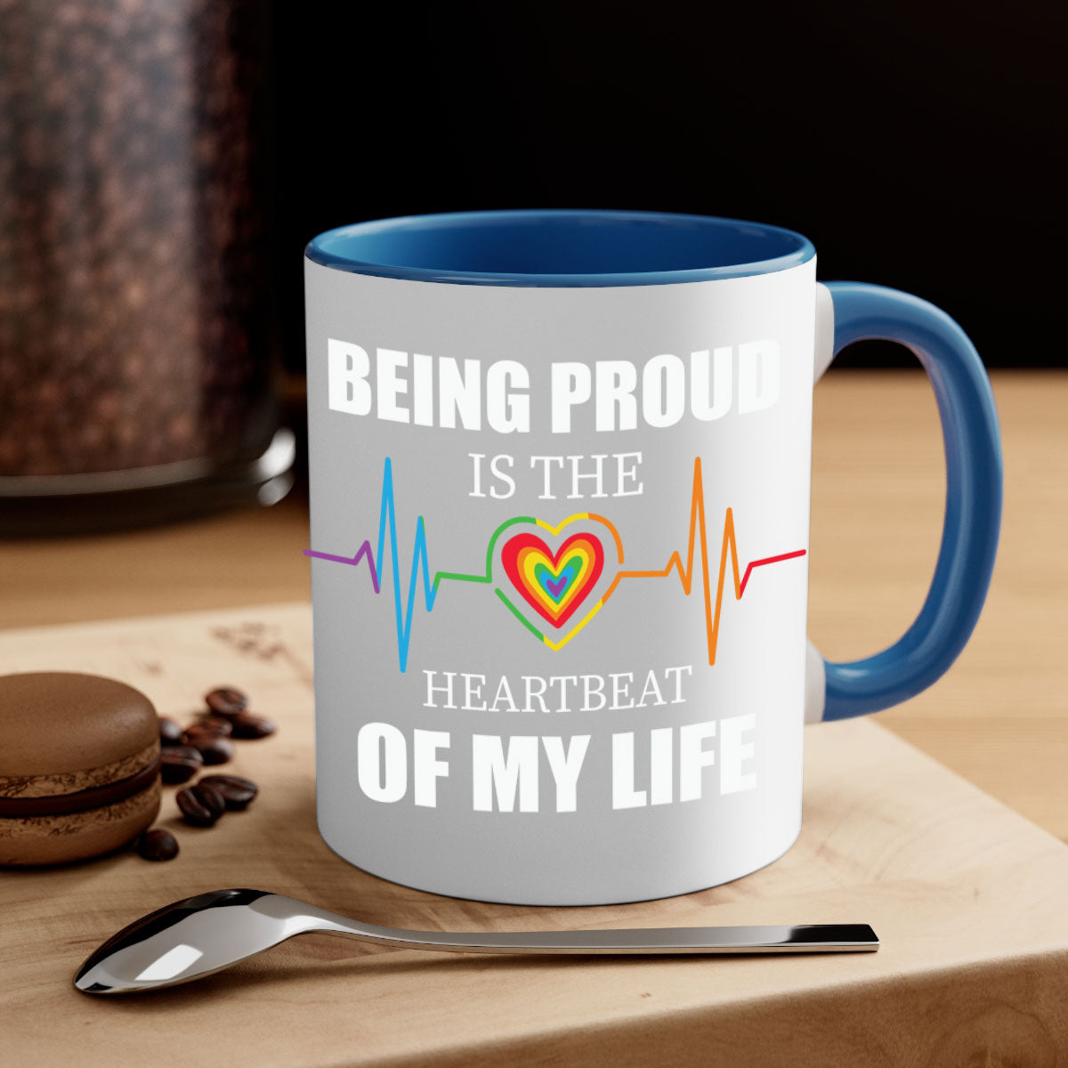 Being Proud is the Heartbeat LGBT Mug with colorful handle and interior, showcasing a glossy finish.