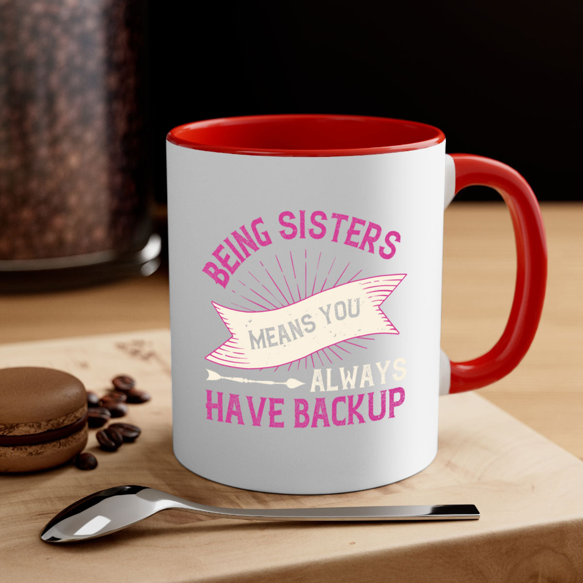 A stylish two-tone ceramic mug with a colored handle and interior, featuring the phrase 'Being Sisters Means You Always Have Backup'.