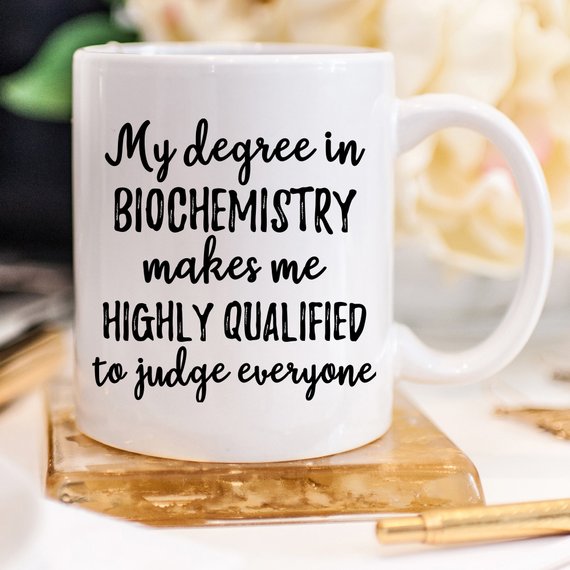 A white ceramic Biochemistry Mug featuring a vibrant design on both sides, perfect for coffee or tea.
