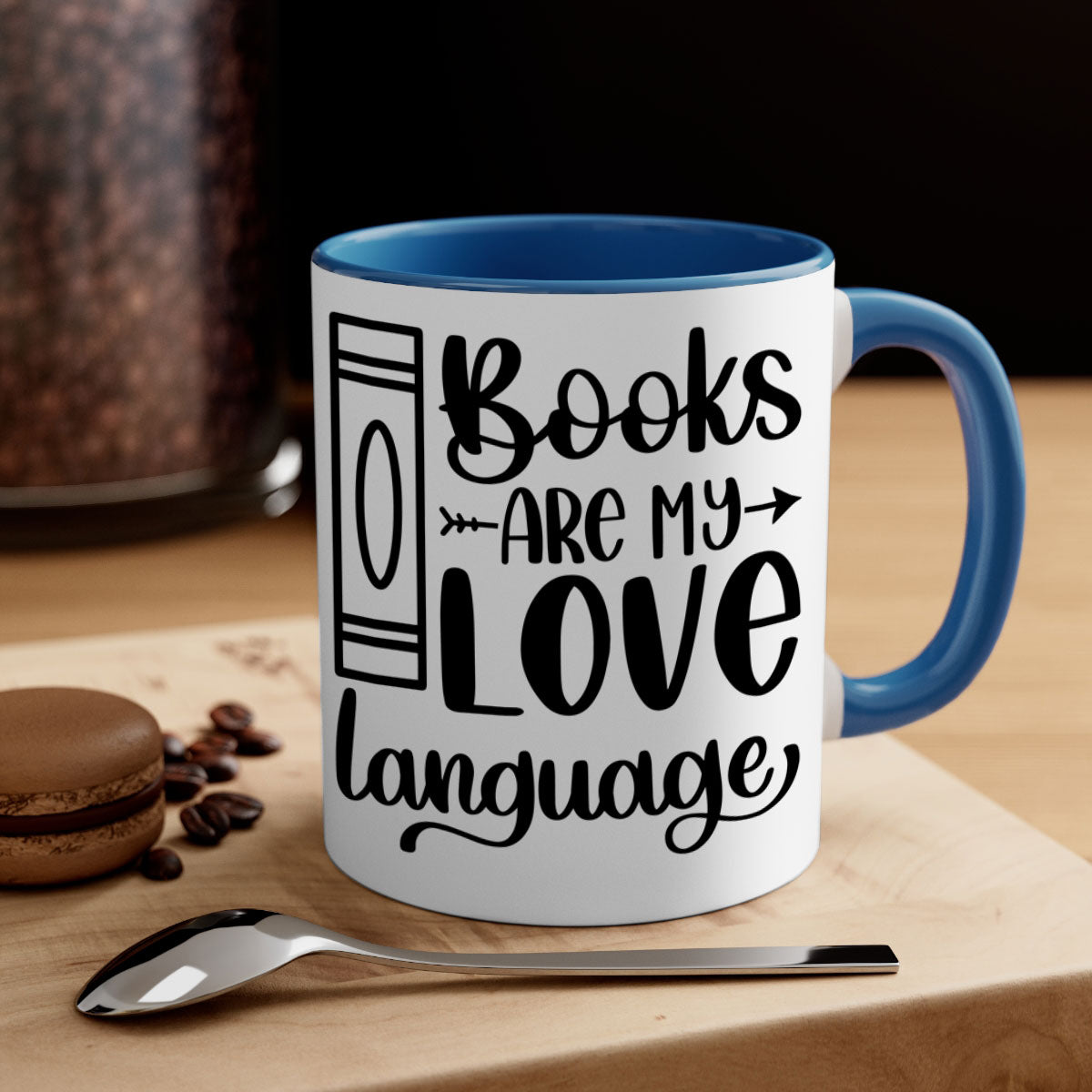 A stylish two-tone ceramic mug with the phrase 'Books Are My Love Language', featuring a colored handle and glossy finish.