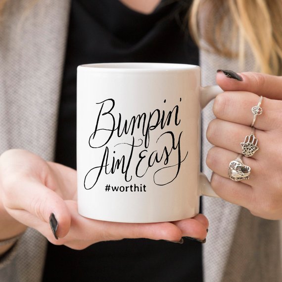 Bumpin Aint Easy Mug featuring humorous text for new moms, crafted from high-quality ceramic, ideal for coffee or tea.