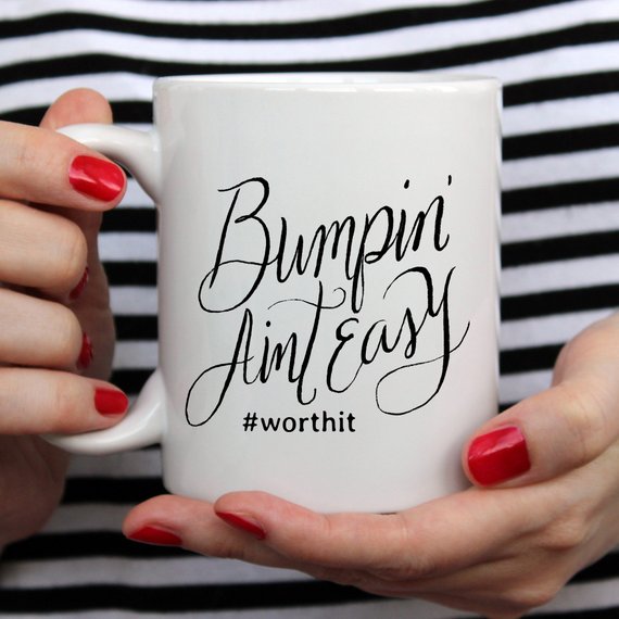 Bumpin Aint Easy Mug featuring humorous text for new moms, crafted from high-quality ceramic, ideal for coffee or tea.
