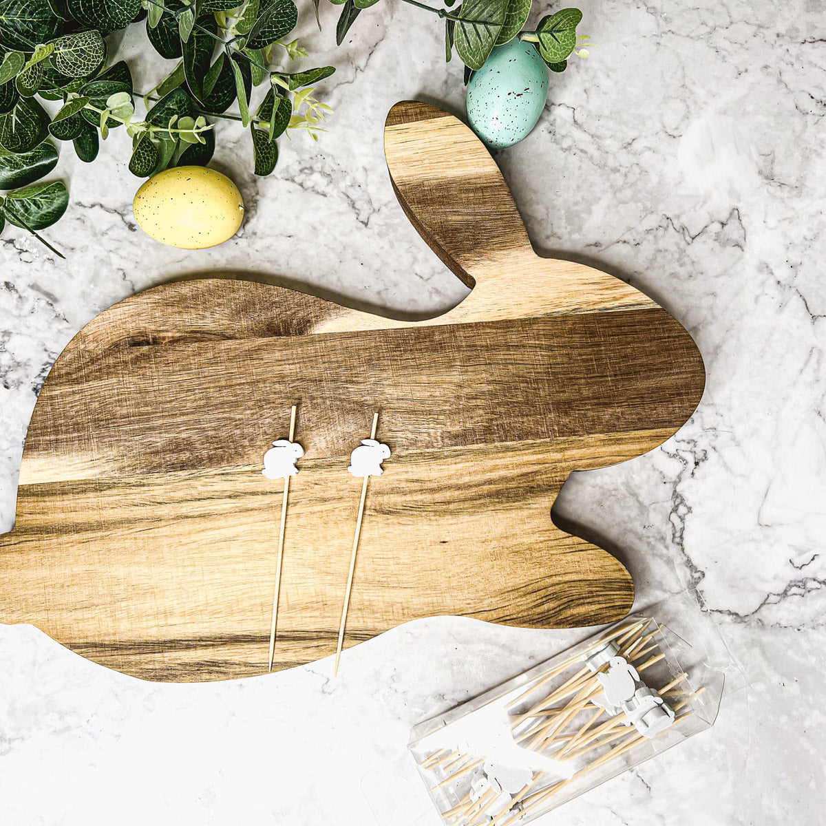Bunny Board + Toothpick Set featuring an acacia wood cutting board with cute bunny toothpicks, perfect for Easter celebrations.
