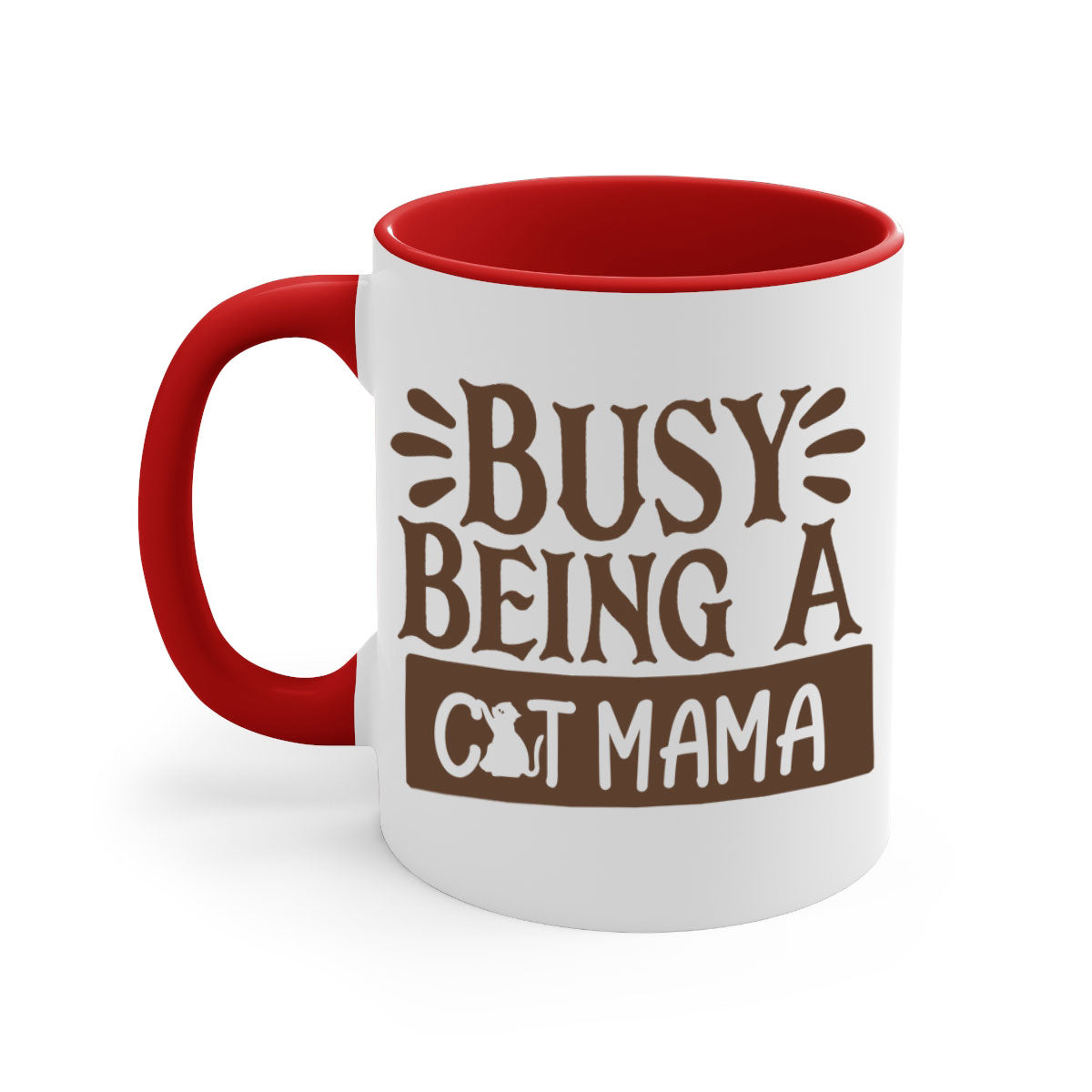 A two-tone ceramic mug with a colored handle and interior, featuring the phrase 'Busy Being A Cat Mama' in a stylish font.