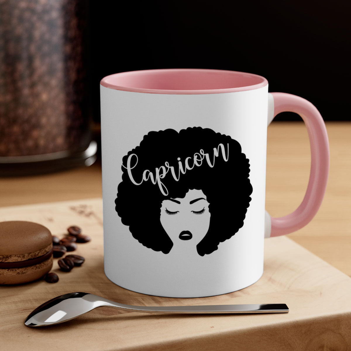 A stylish black ceramic mug with a colored handle and interior, designed for Black women, showcasing a glossy finish.