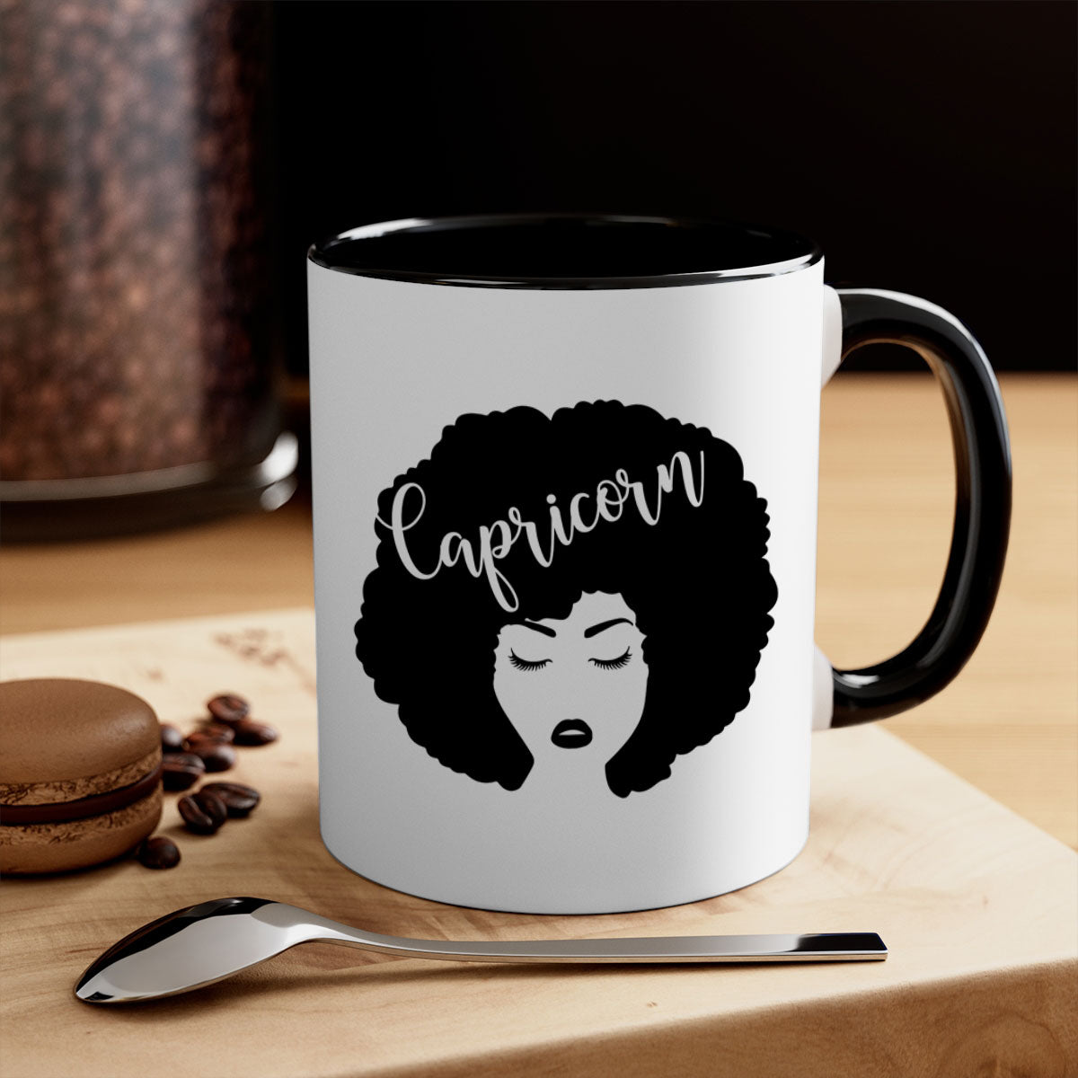 A stylish black ceramic mug with a colored handle and interior, designed for Black women, showcasing a glossy finish.