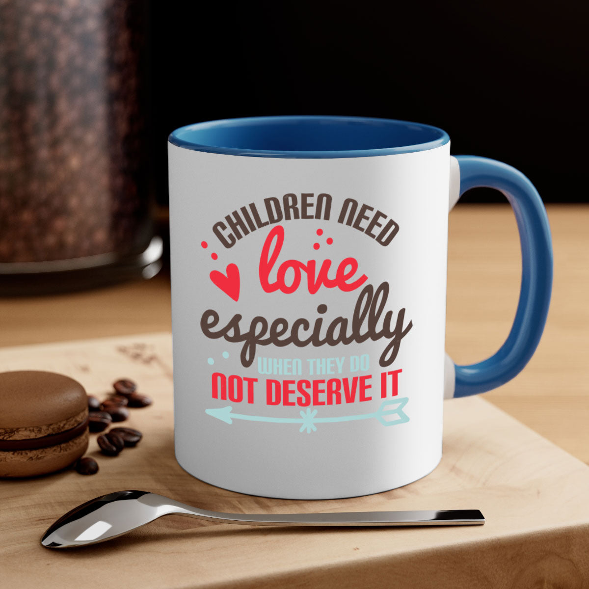 A stylish two-tone ceramic mug with a colored handle and glossy finish, featuring the phrase 'Children need love especially when they do not deserve it'.