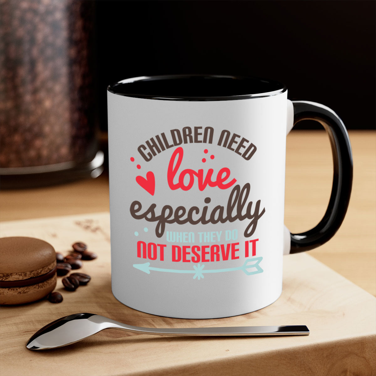 A stylish two-tone ceramic mug with a colored handle and glossy finish, featuring the phrase 'Children need love especially when they do not deserve it'.