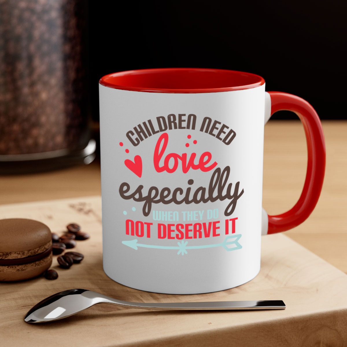 A stylish two-tone ceramic mug with a colored handle and glossy finish, featuring the phrase 'Children need love especially when they do not deserve it'.