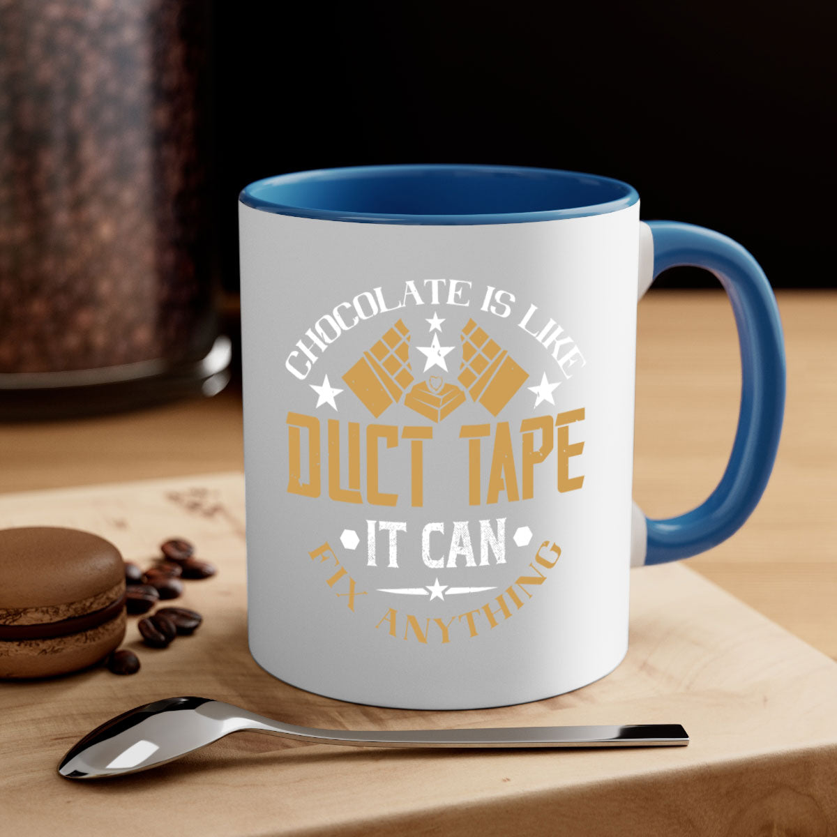 A two-tone ceramic mug with a humorous quote 'Chocolate is Like Duct Tape It Can Fix Anything', featuring a colored handle and glossy finish.