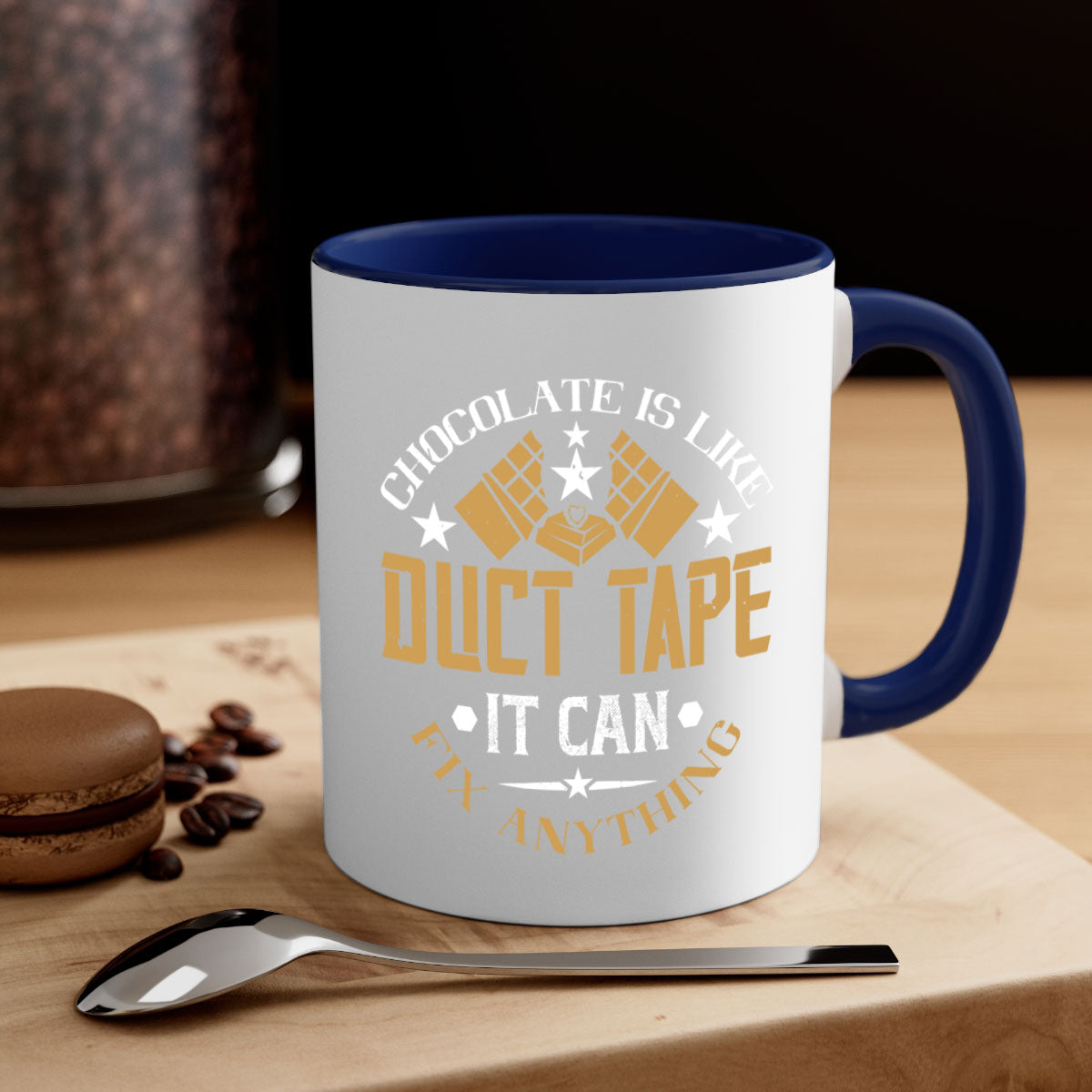A two-tone ceramic mug with a humorous quote 'Chocolate is Like Duct Tape It Can Fix Anything', featuring a colored handle and glossy finish.