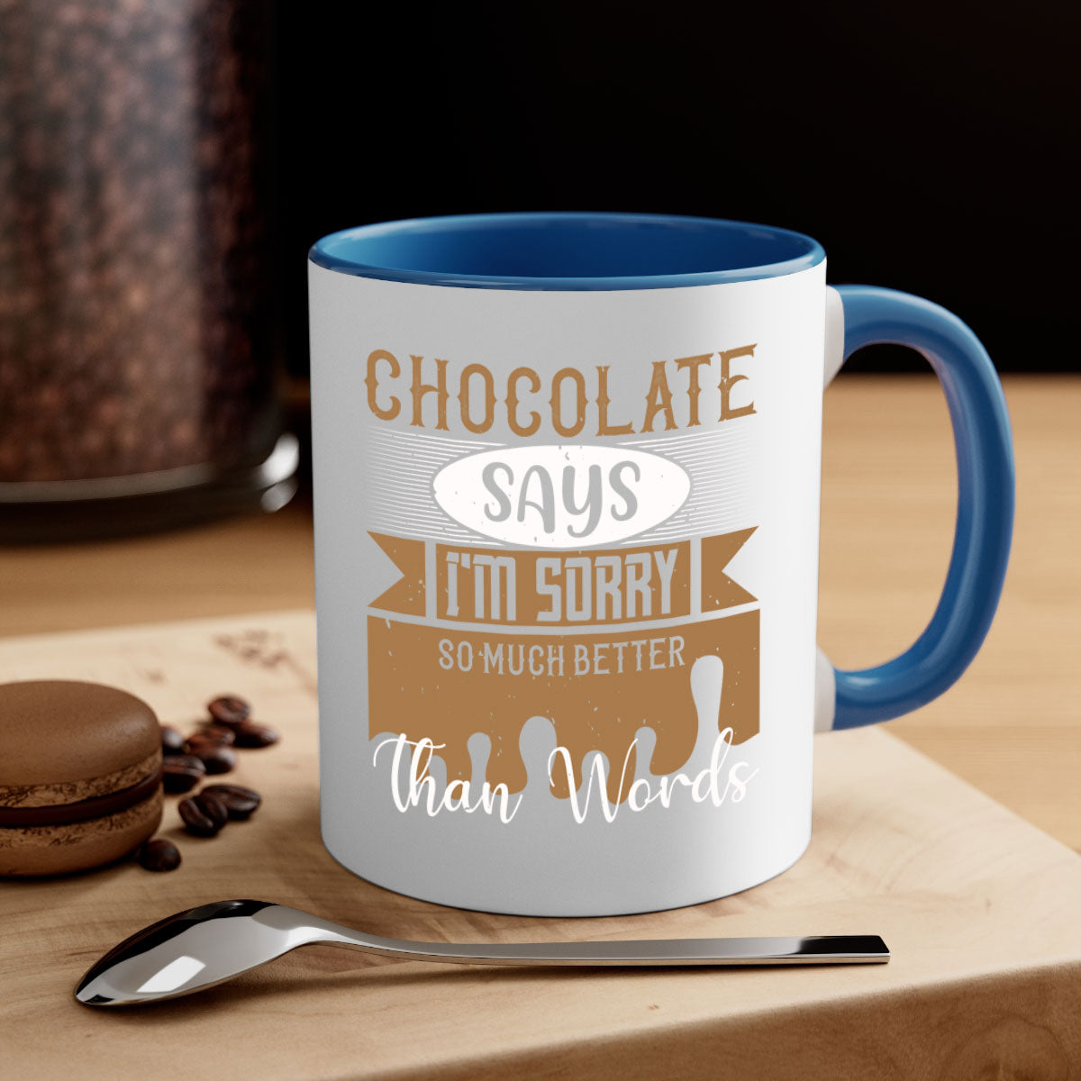 A stylish two-tone ceramic mug with a colored handle and glossy finish, featuring the phrase 'Chocolate Says I'm Sorry So Much Better Than Words'.