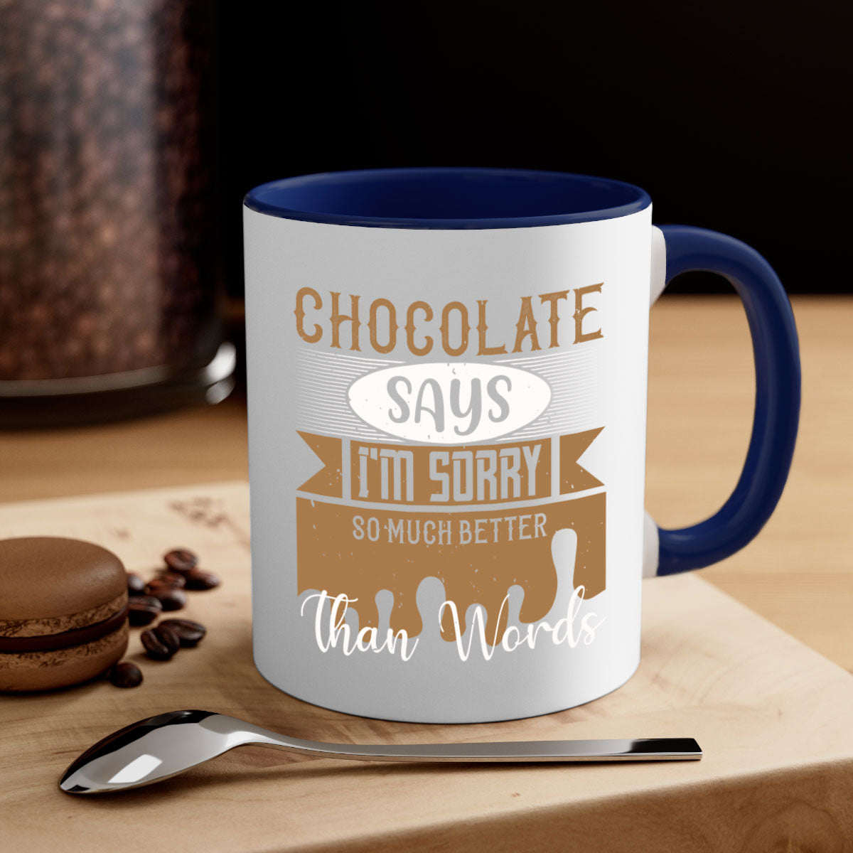 A stylish two-tone ceramic mug with a colored handle and glossy finish, featuring the phrase 'Chocolate Says I'm Sorry So Much Better Than Words'.