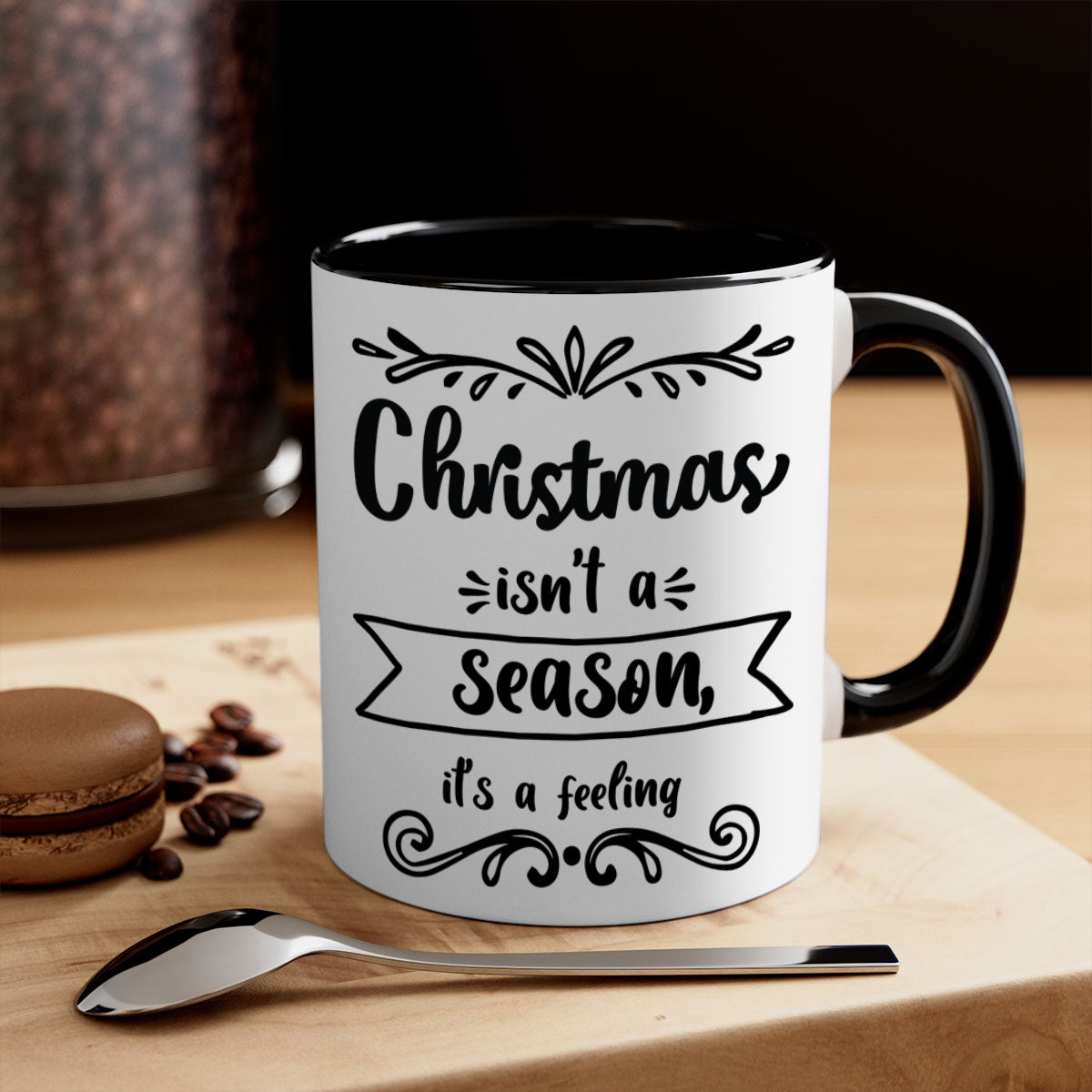 A festive two-tone Christmas mug with a colored handle and interior, featuring the phrase 'Christmas Isn't a Season, It's a Feeling'.