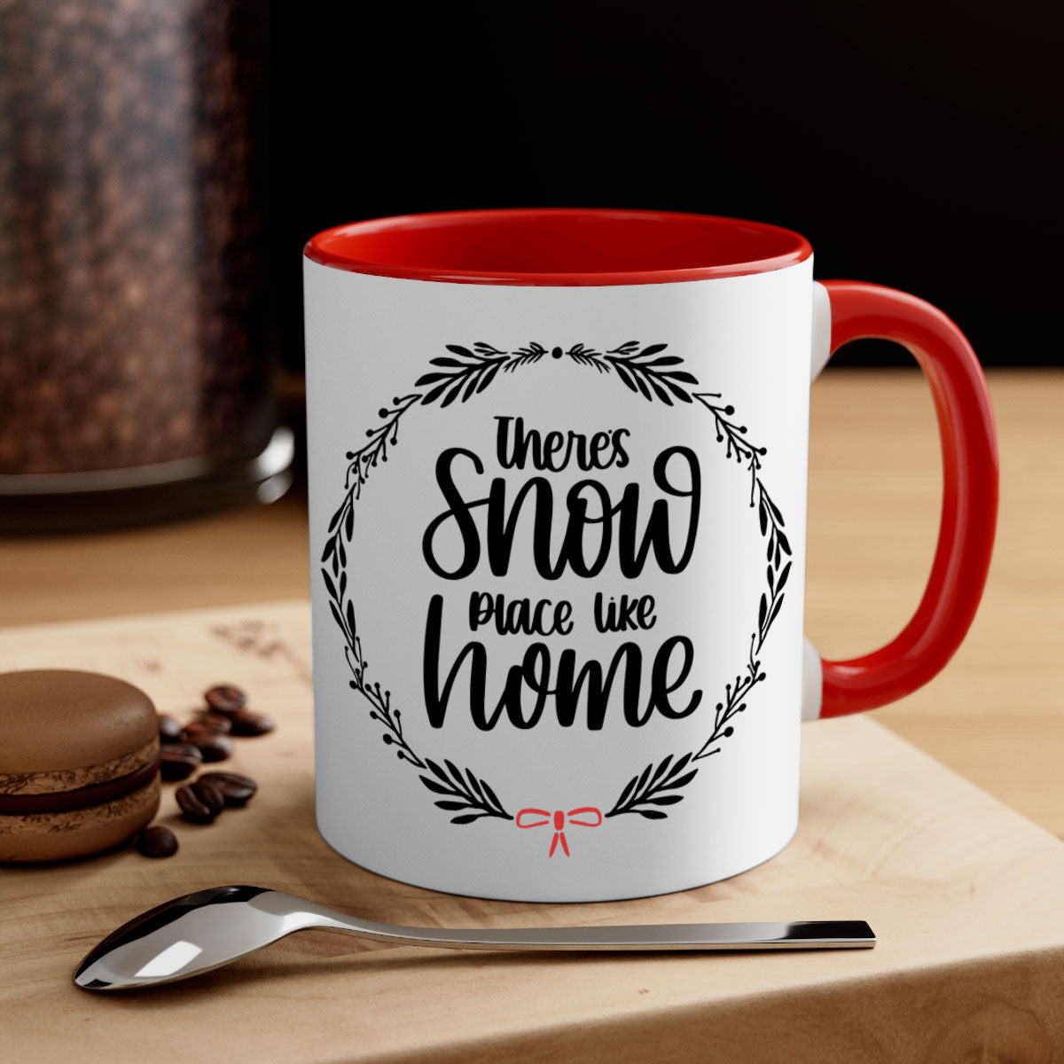 A festive Christmas ornament mug with a two-tone design, featuring a colored handle and interior, showcasing the phrase 'there's snow place like home'.