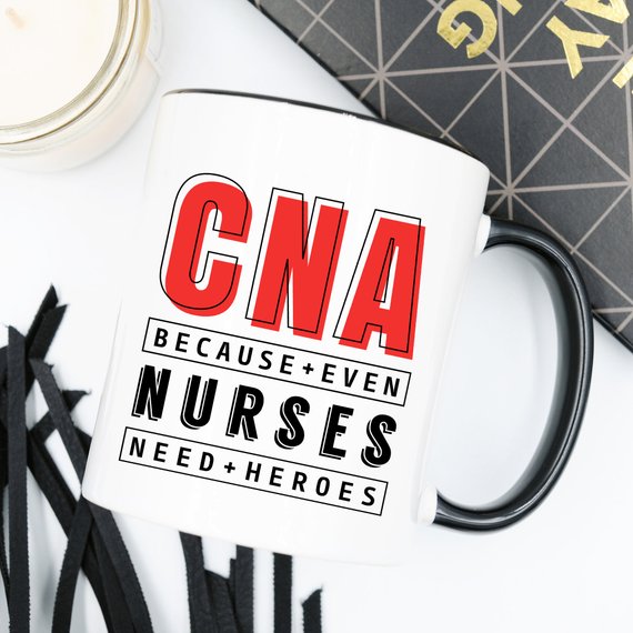 CNA - Because Even Nurses Need Heroes coffee mug featuring a humorous design, perfect for nurses and healthcare workers.