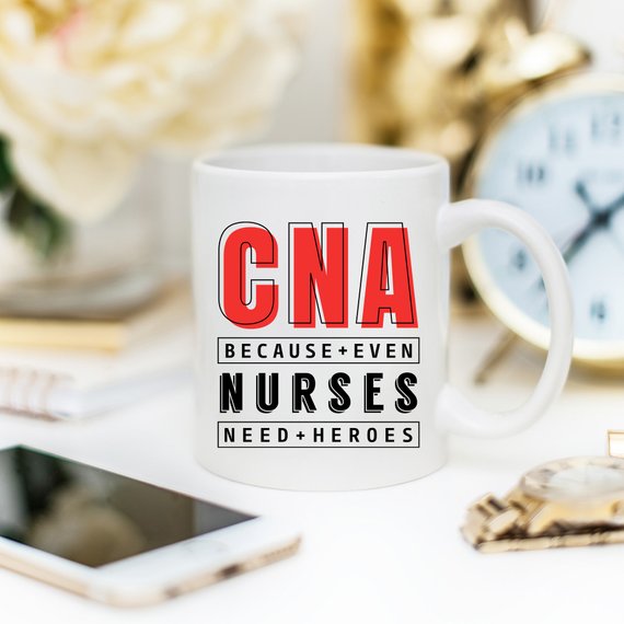 CNA - Because Even Nurses Need Heroes coffee mug featuring a humorous design, perfect for nurses and healthcare workers.