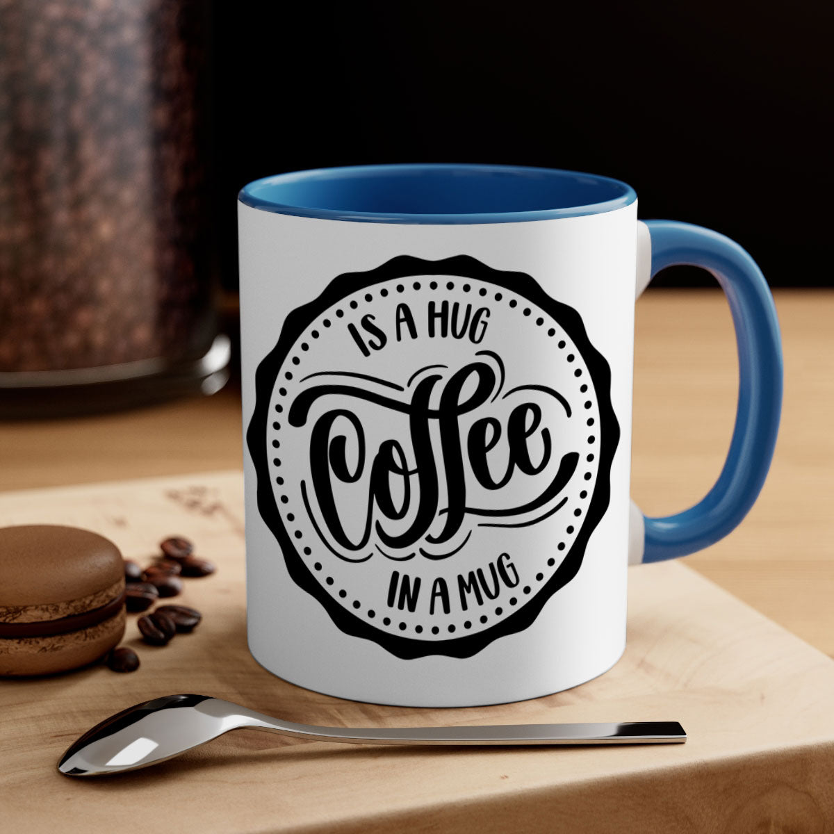A stylish two-tone coffee mug with a colored handle and glossy finish, featuring the phrase 'Coffee is a Hug in a Mug'.