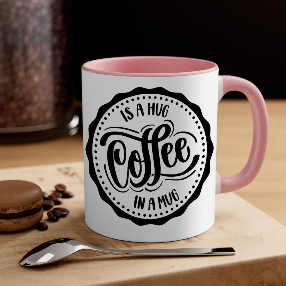 A stylish two-tone coffee mug with a colored handle and glossy finish, featuring the phrase 'Coffee is a Hug in a Mug'.