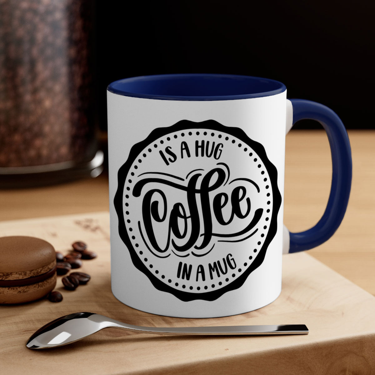 A stylish two-tone coffee mug with a colored handle and glossy finish, featuring the phrase 'Coffee is a Hug in a Mug'.