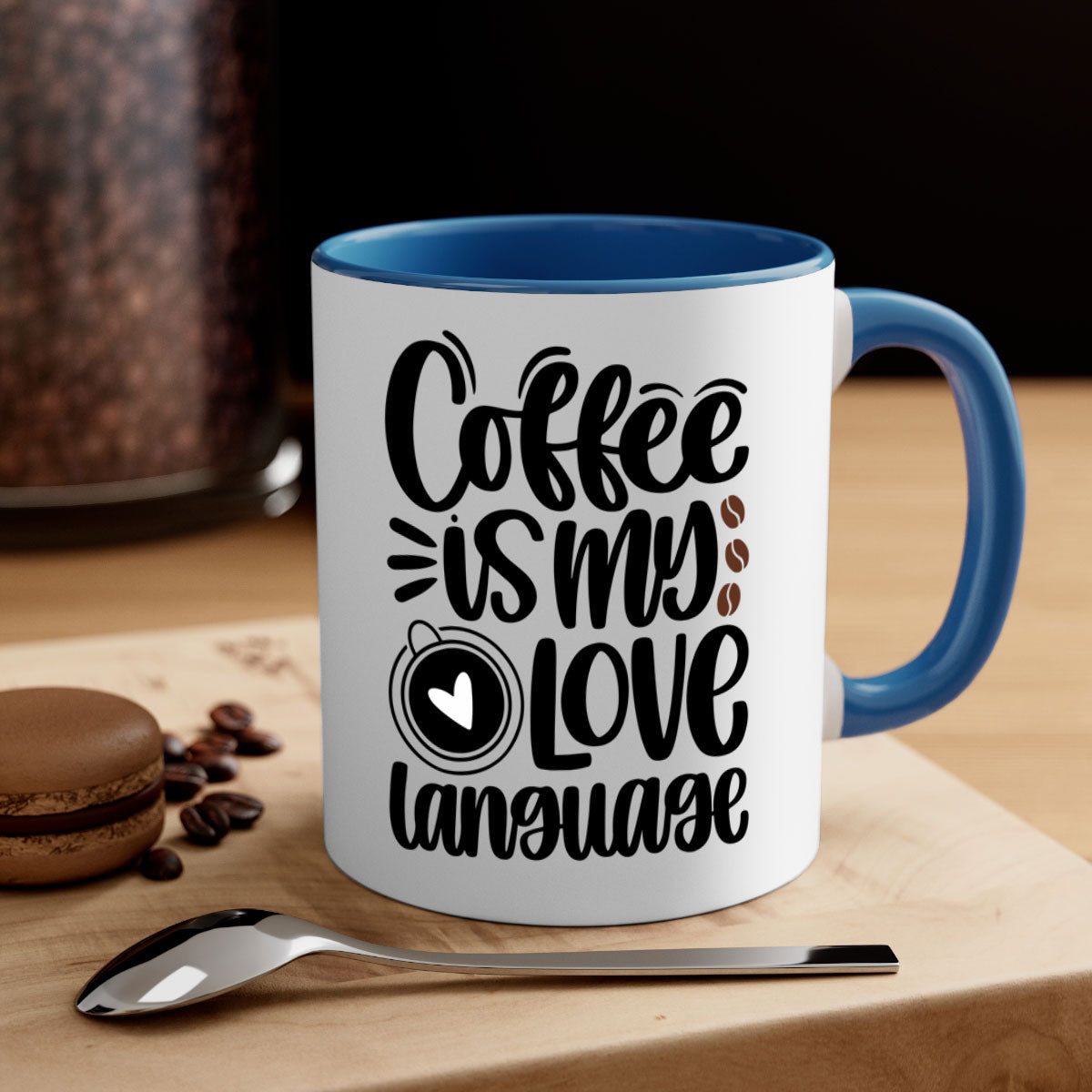 A two-tone ceramic coffee mug with the phrase 'Coffee is My Love Language' printed on it, featuring a colored handle and glossy finish.