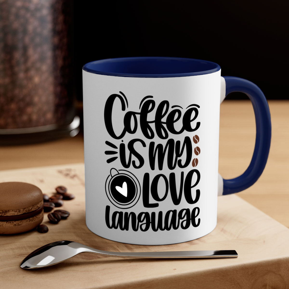 A two-tone ceramic coffee mug with the phrase 'Coffee is My Love Language' printed on it, featuring a colored handle and glossy finish.