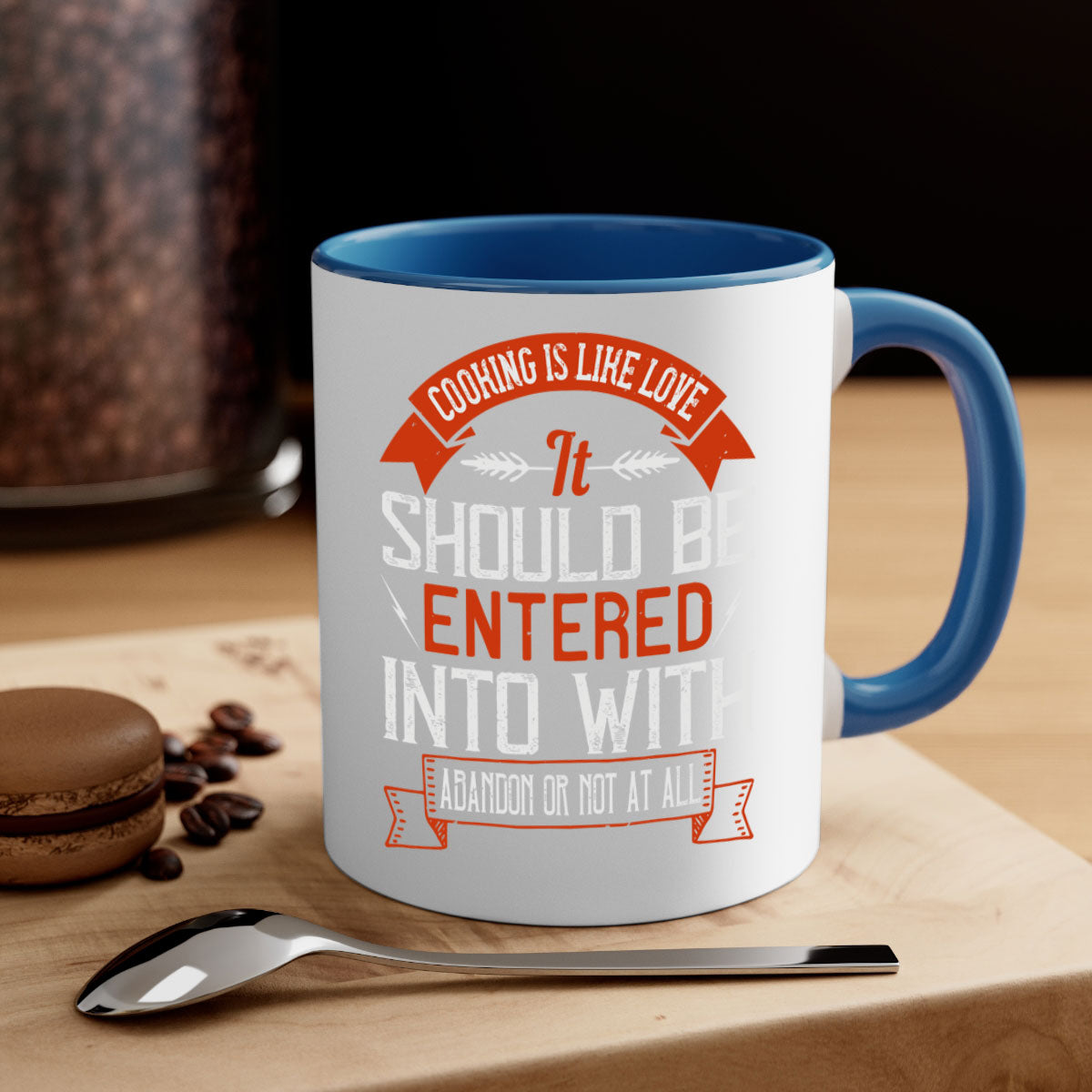 A stylish two-tone ceramic mug with the quote 'Cooking is Like Love' in a glossy finish, featuring a colored handle and interior.