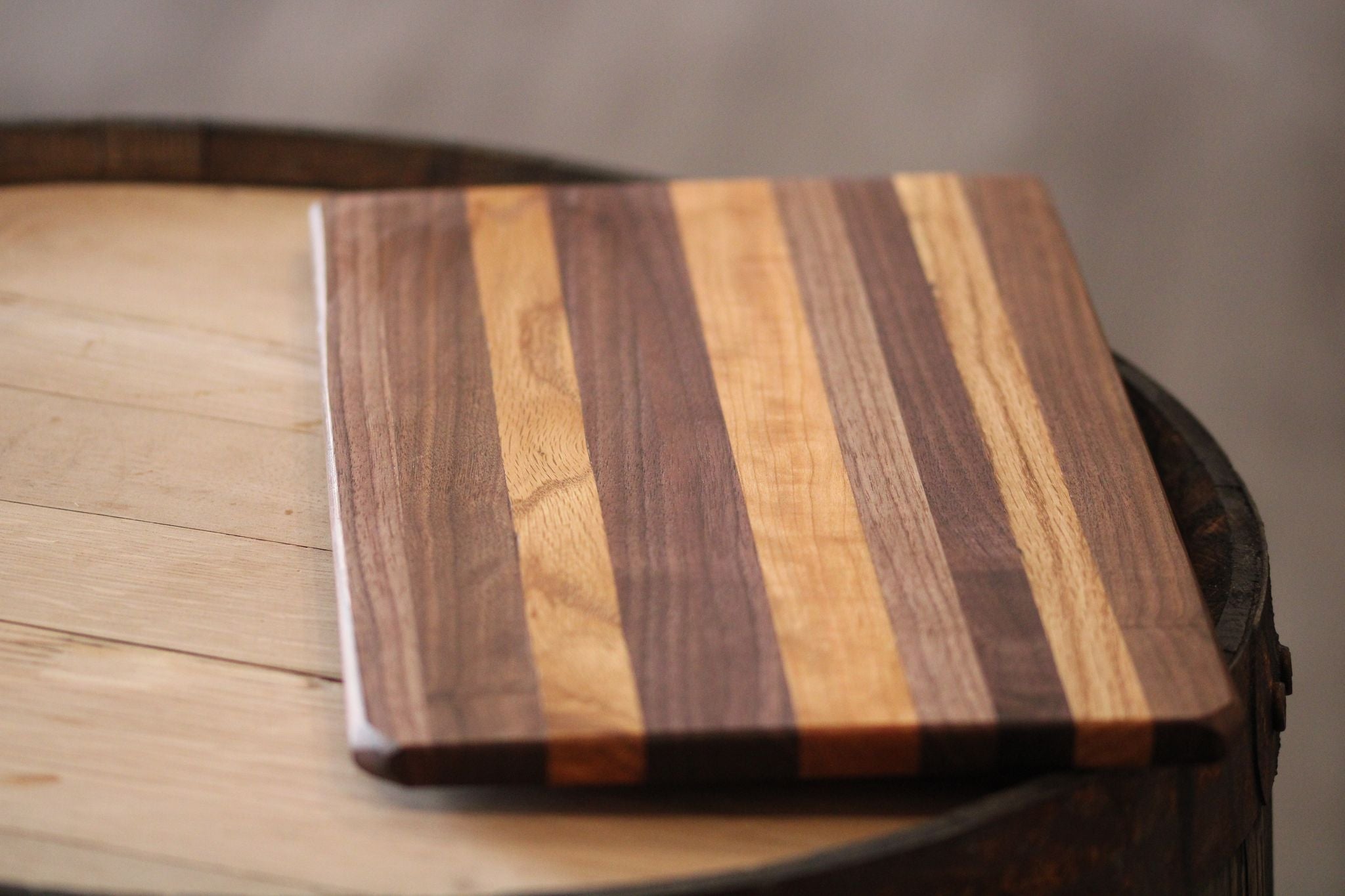 A beautifully crafted mixed hardwood cutting board, measuring 15.5" x 9" x 5/8", showcasing unique wood grains and a polished finish.