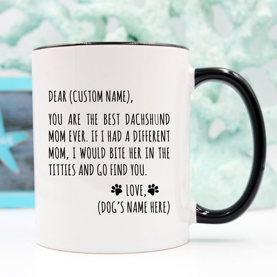A stylish white ceramic mug featuring a vibrant dachshund design, perfect for dachshund moms, available in 11 and 15 oz sizes.