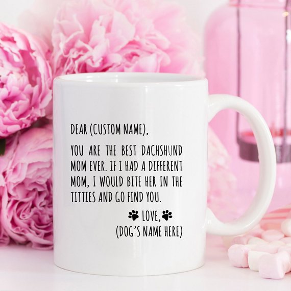 A stylish white ceramic mug featuring a vibrant dachshund design, perfect for dachshund moms, available in 11 and 15 oz sizes.