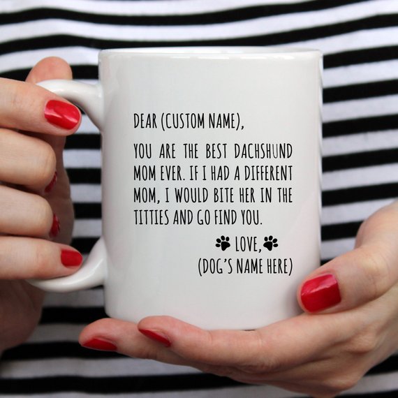 A stylish white ceramic mug featuring a vibrant dachshund design, perfect for dachshund moms, available in 11 and 15 oz sizes.