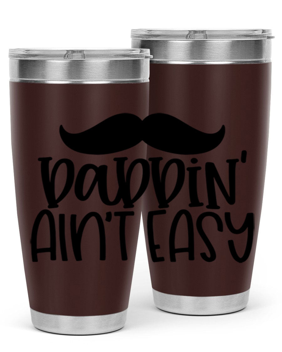 20oz stainless steel tumbler with 'Daddin Aint Easy' print, featuring a drink-thru lid and double wall vacuum insulation.