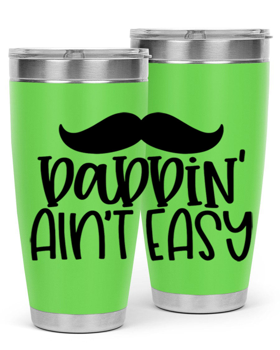 20oz stainless steel tumbler with 'Daddin Aint Easy' print, featuring a drink-thru lid and double wall vacuum insulation.
