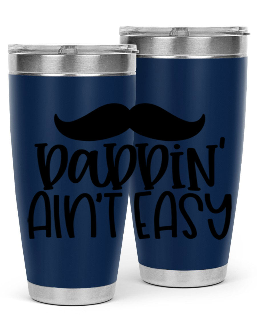 20oz stainless steel tumbler with 'Daddin Aint Easy' print, featuring a drink-thru lid and double wall vacuum insulation.