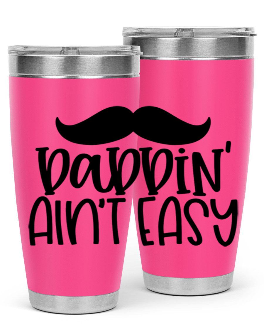 20oz stainless steel tumbler with 'Daddin Aint Easy' print, featuring a drink-thru lid and double wall vacuum insulation.