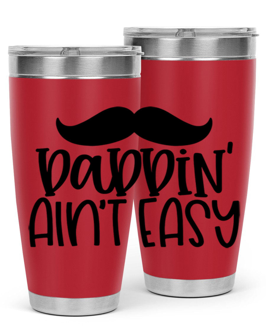 20oz stainless steel tumbler with 'Daddin Aint Easy' print, featuring a drink-thru lid and double wall vacuum insulation.